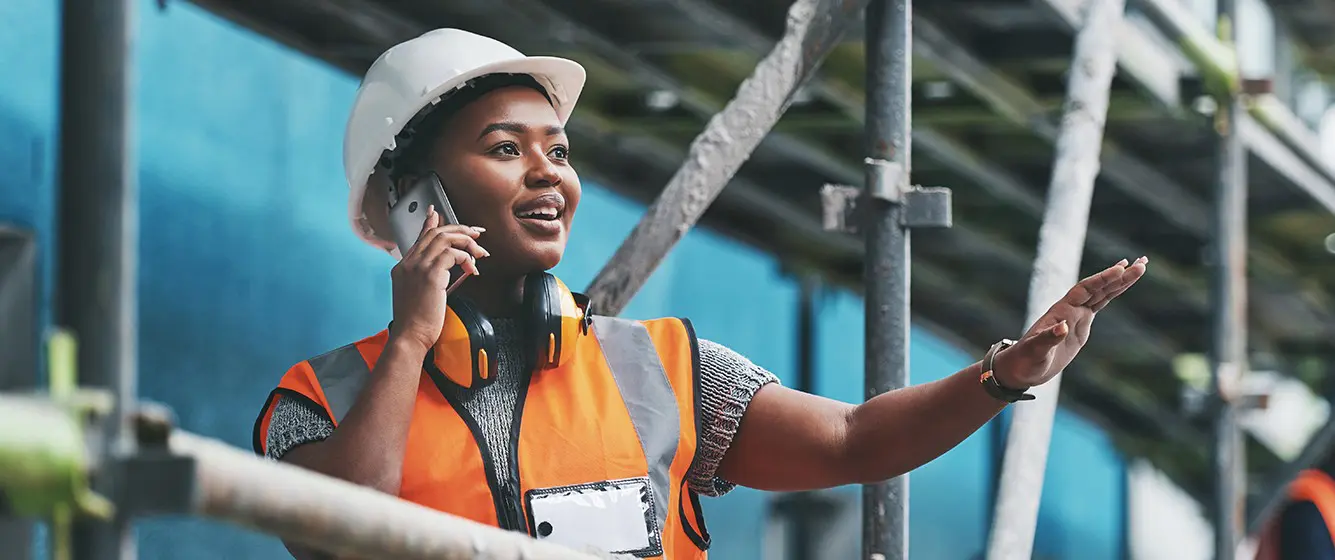 female construction worker on phone